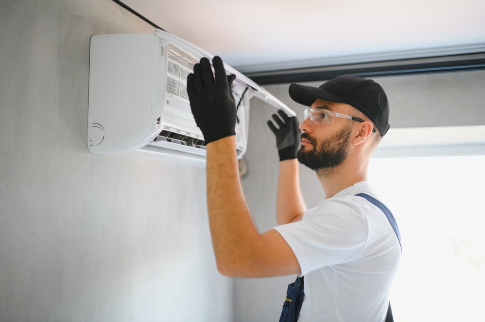 Happy,male,technician,repairing,air,conditioner.