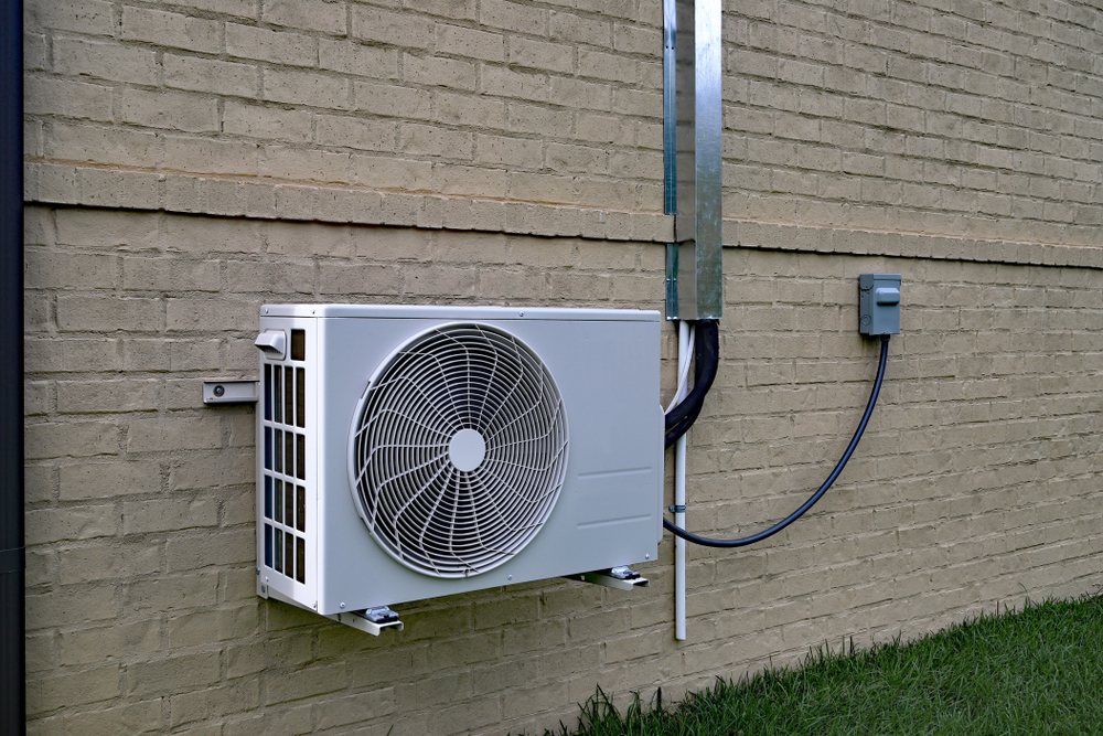 Air,conditioner,mini,split,system,mounted,on,brick,wall,with