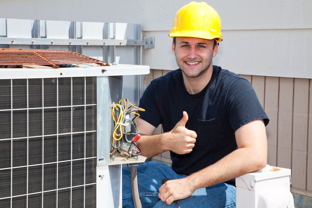 Air,conditioning,repairman,working,on,a,compressor,and,giving,a